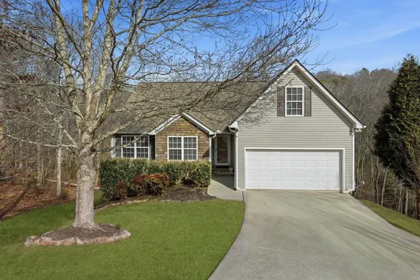 a front view of a house with a yard and garage