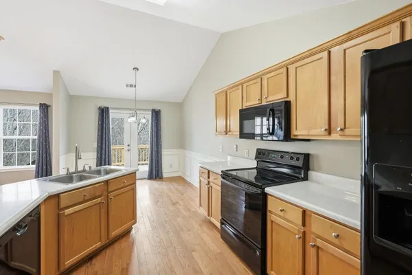 a kitchen with stainless steel appliances granite countertop a sink stove and microwave