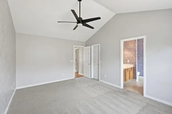 a view of a livingroom with a ceiling fan and wooden floor