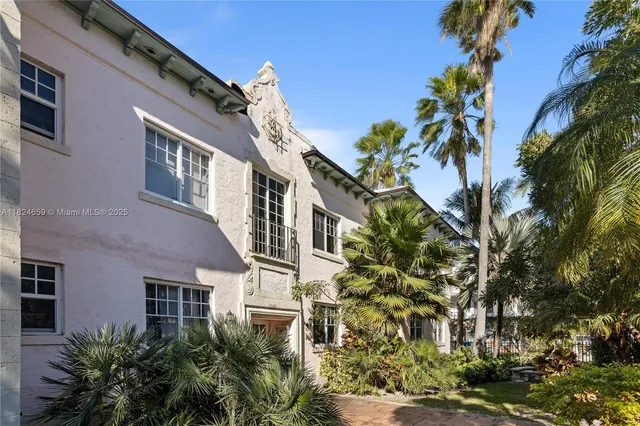 a view of a patio with couches and a table and chairs with wooden fence