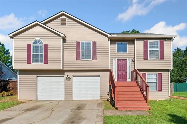 a front view of a house with a yard and garage