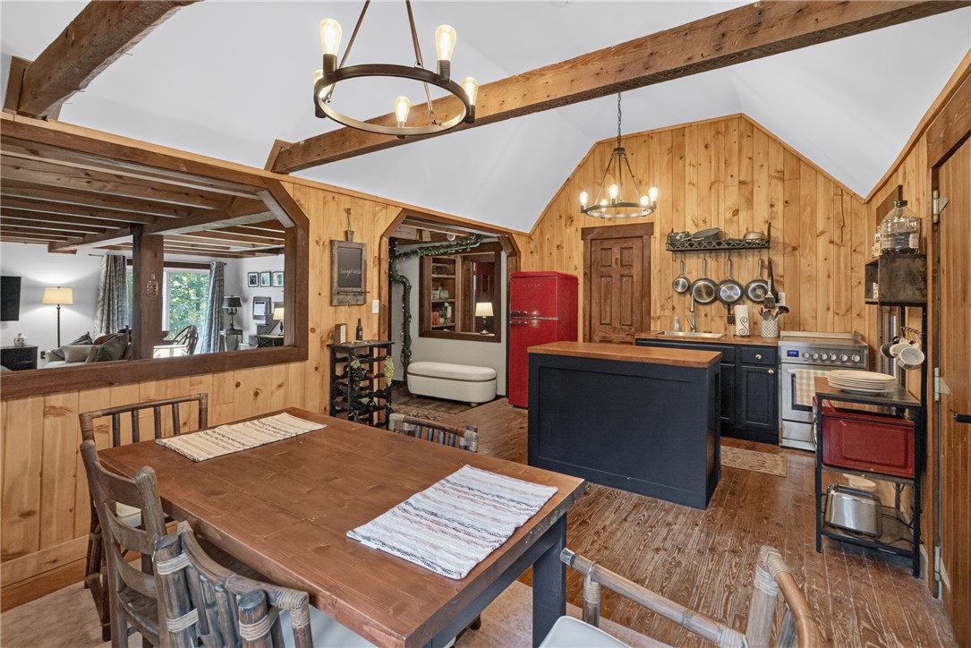 130 Maggie Rufus Lane Westminster, SC 29693 - Photo 9 of 50 Natural wood paneling and exposed beams create a cozy, rustic atmosphere for comfortable dining and cooking.
