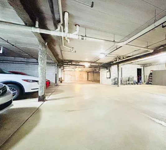 a view of parking garage with cars