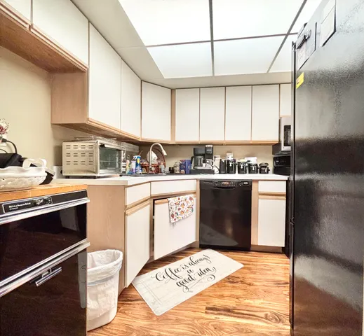 a dining room with furniture a chandelier and wooden floor