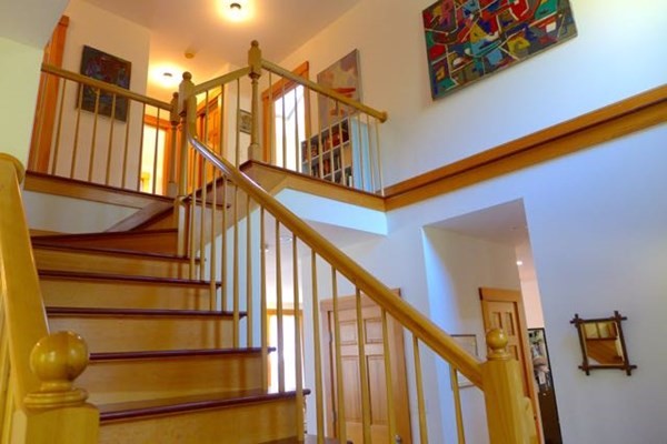 267 Great Plains Road West Tisbury, MA 02568 - Photo 14 of 34 a view of staircase with lots of frames on wall and wooden floor