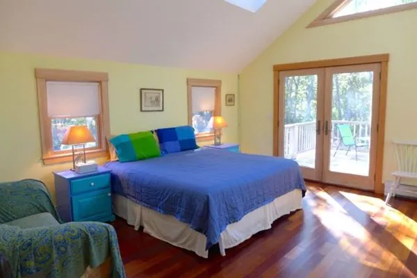 a bed sitting in a bedroom next to a window