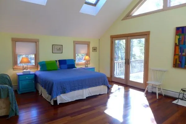 a bedroom with a large bed and a large window