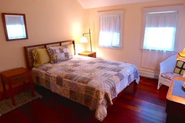 a bedroom with a bed and window