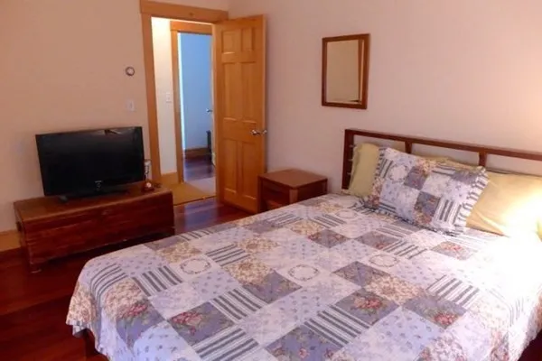 a bedroom with a bed and a flat screen tv