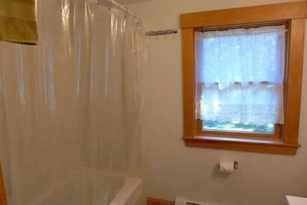 a bathroom with a shower and a window