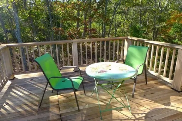 a view of a chairs and table in the balcony