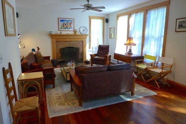 267 Great Plains Road West Tisbury, MA 02568 - Photo 3 of 34 a living room with furniture a window and a fireplace
