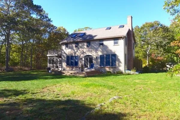 a view of a house with backyard and sitting area