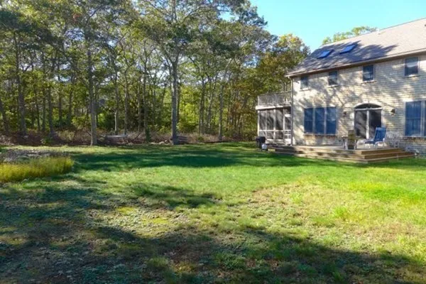 a view of a house with backyard and porch