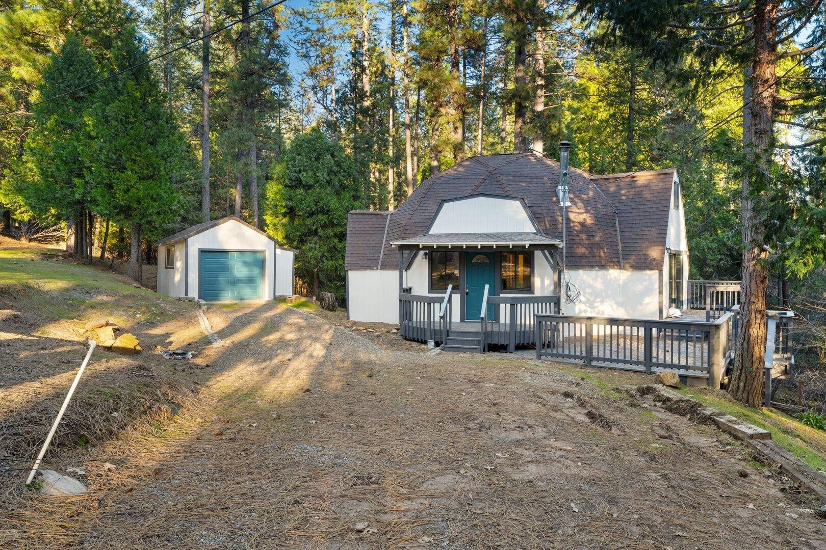 a view of a house with backyard and sitting area