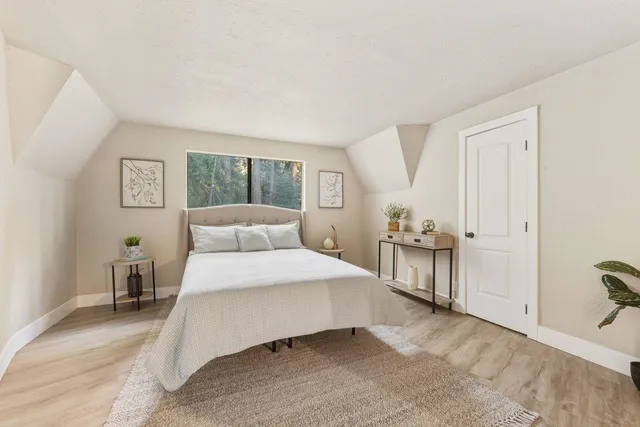 a bedroom with a bed and a large mirror