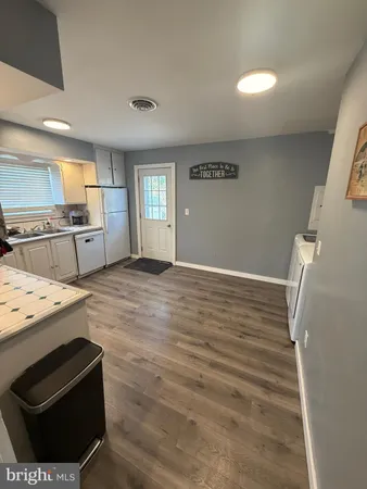 a kitchen with granite countertop a stove and a refrigerator