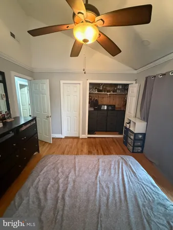 a bedroom with a bed and a mirror on the dresser