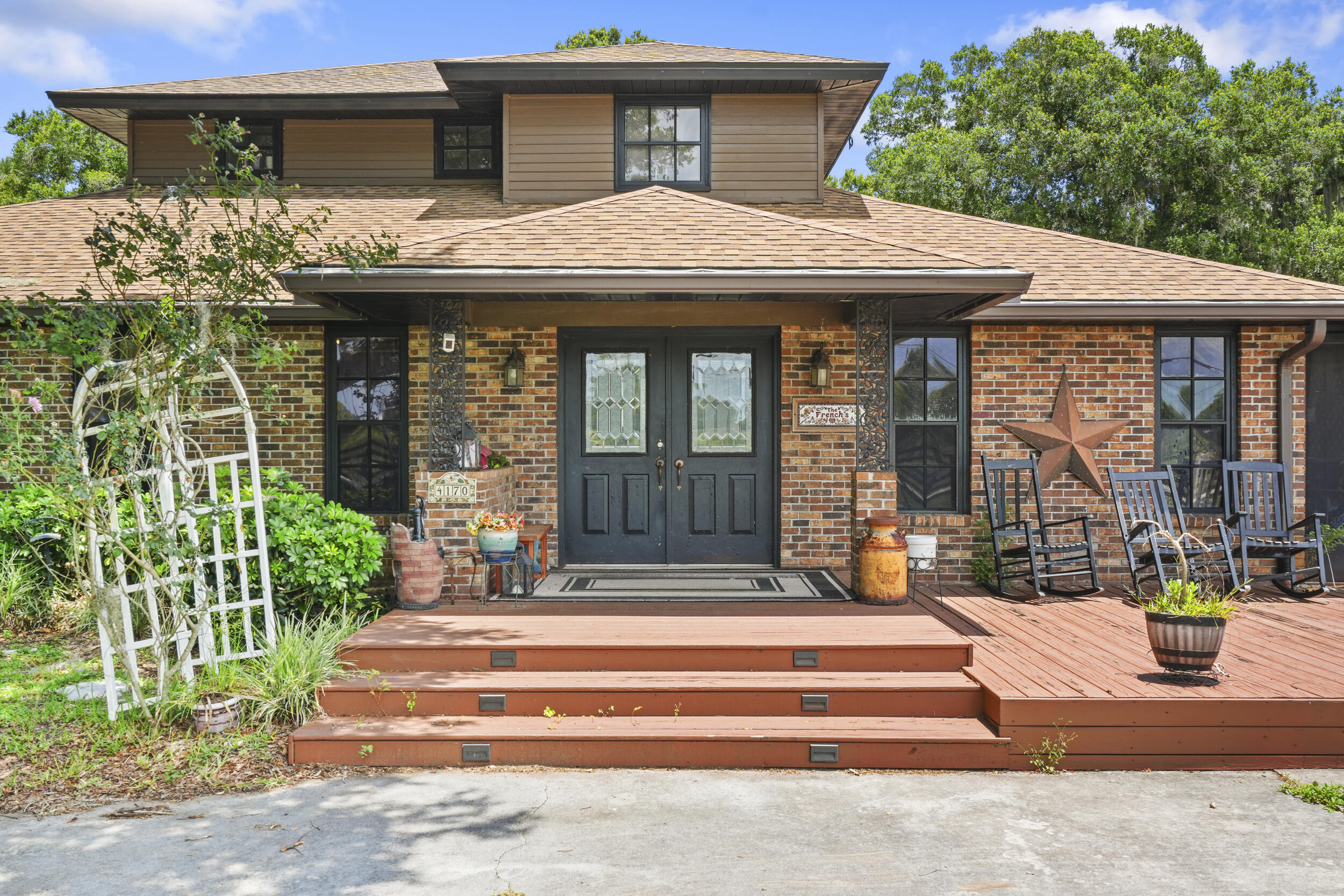 4170 McCarty Road Fort Pierce, FL 34945 - Photo 8 of 57 a front view of a house with a garden and plants