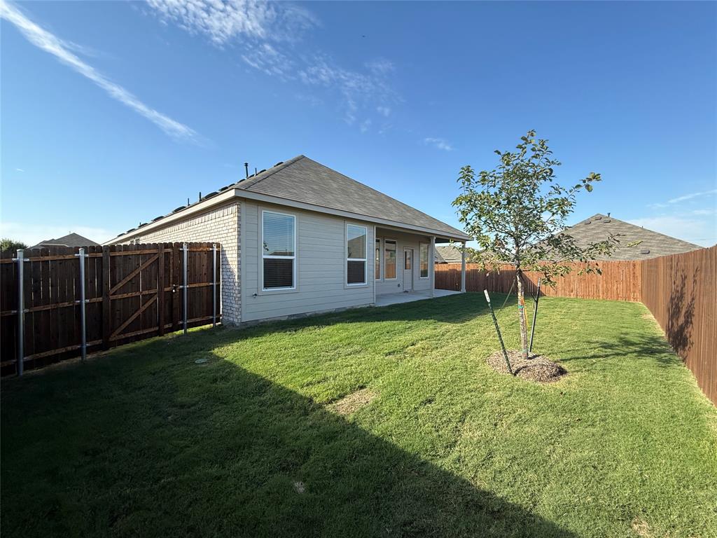 454 Ridge Drive Justin, TX 76247 - Photo 22 of 24 a backyard of a house with lots of green space