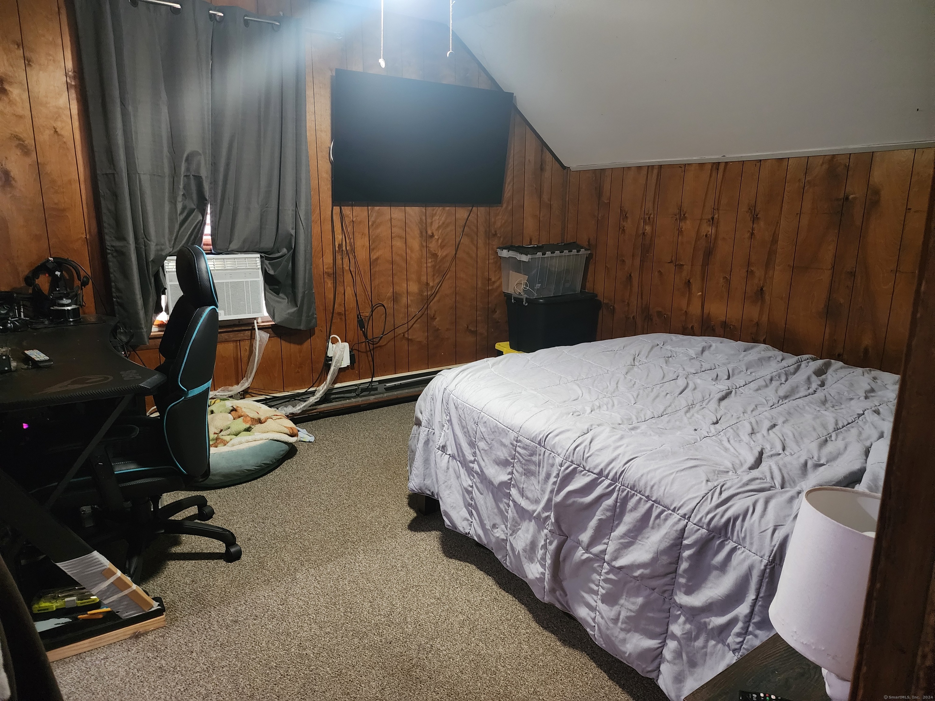5 Avery St Extension Norwich, CT 06360 - Photo 13 of 17 a bedroom with a bed gym equipment and wooden floor