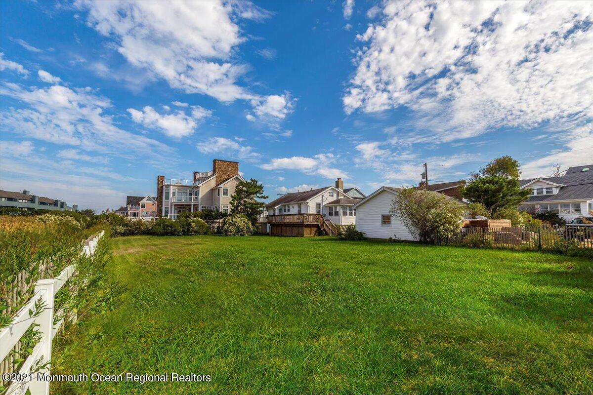 15 Riverview Road Monmouth Beach, NJ 07750 - Photo 11 of 38 a view of a big house with a big yard and a large tree