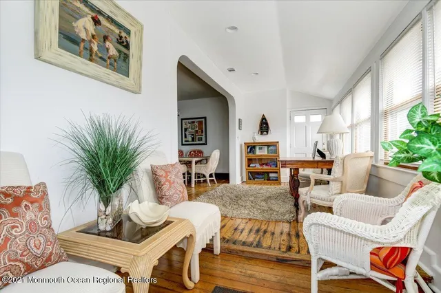 a living room with furniture flowerpot and a window