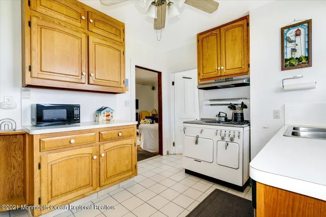 a kitchen with stainless steel appliances granite countertop a sink and dishwasher a stove with wooden floor
