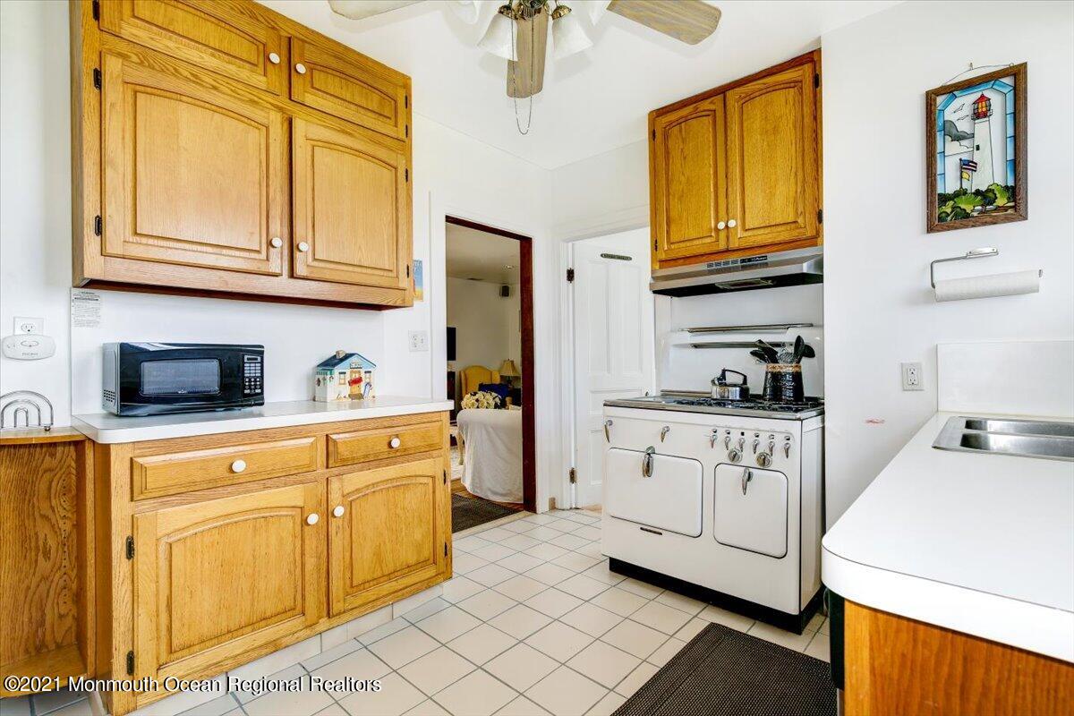15 Riverview Road Monmouth Beach, NJ 07750 - Photo 23 of 38 a kitchen with stainless steel appliances granite countertop a sink and dishwasher a stove with wooden floor