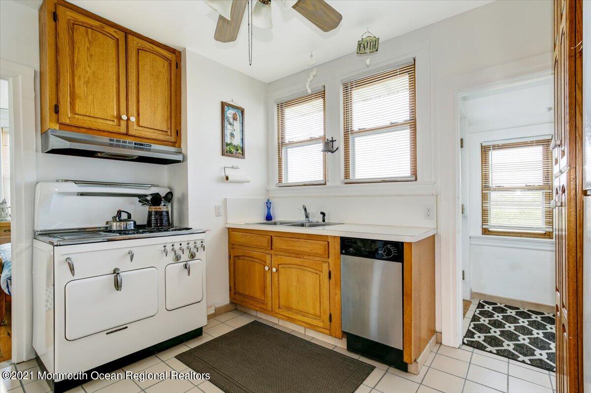 15 Riverview Road Monmouth Beach, NJ 07750 - Photo 24 of 38 a kitchen with stainless steel appliances granite countertop a stove a sink and a microwave