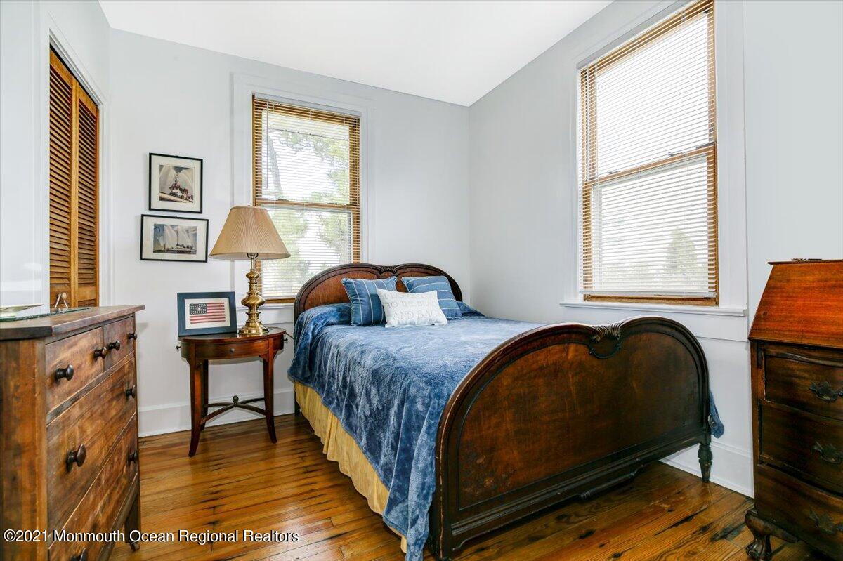 15 Riverview Road Monmouth Beach, NJ 07750 - Photo 26 of 38 a bedroom with a bed and wooden floor