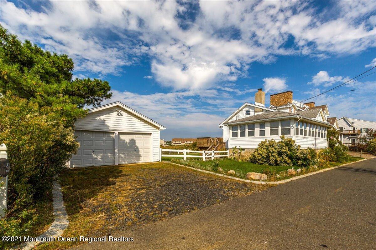 15 Riverview Road Monmouth Beach, NJ 07750 - Photo 3 of 38 a front view of a house with a garden