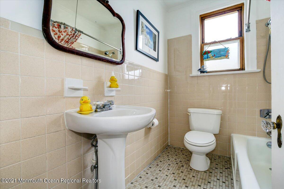 15 Riverview Road Monmouth Beach, NJ 07750 - Photo 32 of 38 a bathroom with a toilet sink and mirror