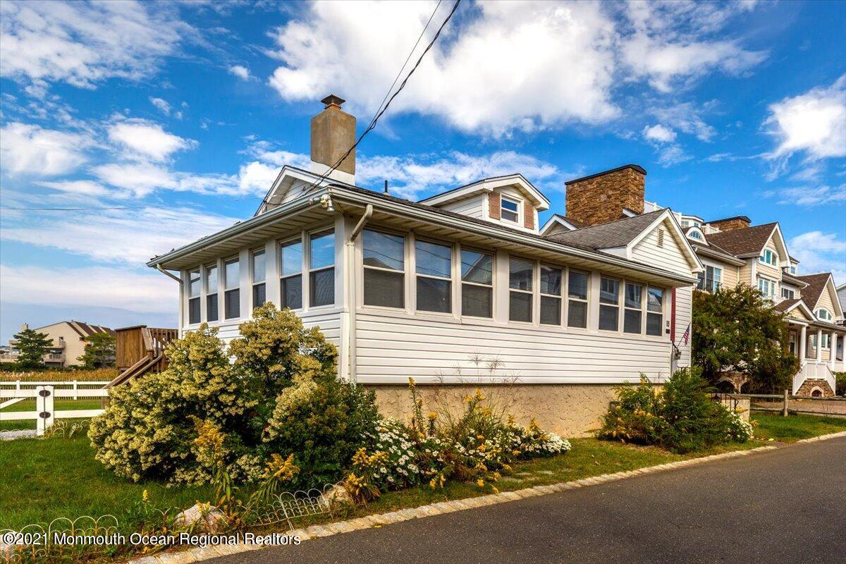 15 Riverview Road Monmouth Beach, NJ 07750 - Photo 4 of 38 a front view of a house with a garden