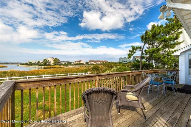 a view of a balcony with wooden floor and city view
