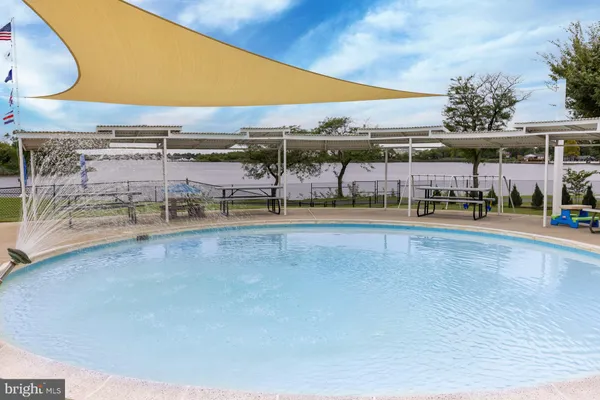 a view of a swimming pool with a lawn chairs