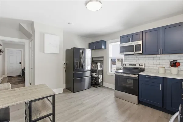 a kitchen with stainless steel appliances granite countertop a refrigerator stove and sink