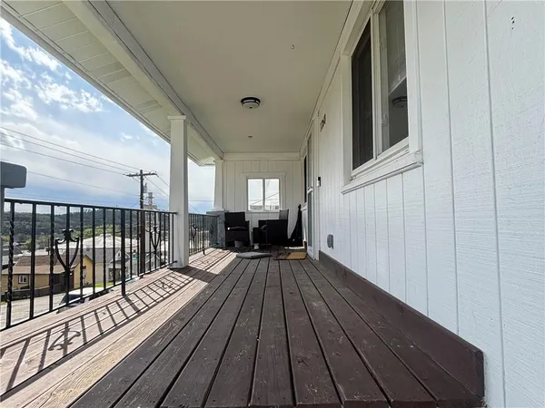 a view of a balcony with wooden floor