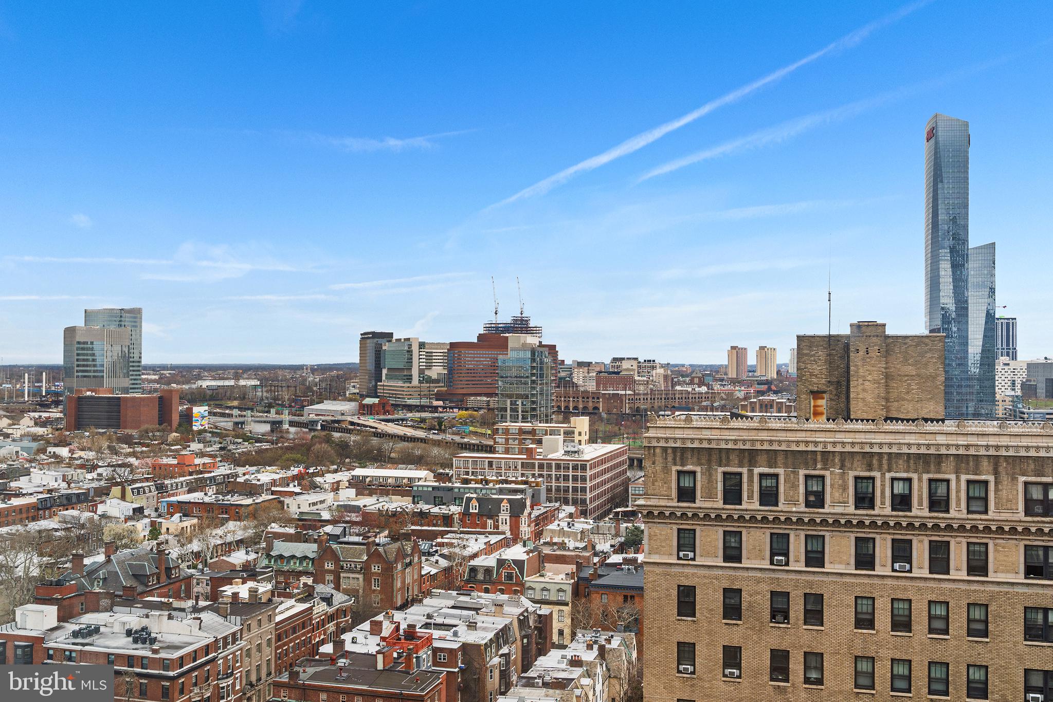 2018 Walnut Street, Unit 21L Philadelphia, PA 19103 - Photo 31 of 39 Urban skyline under a clear blue sky.
