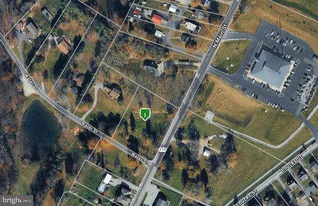 an aerial view of a residential apartment building with a yard