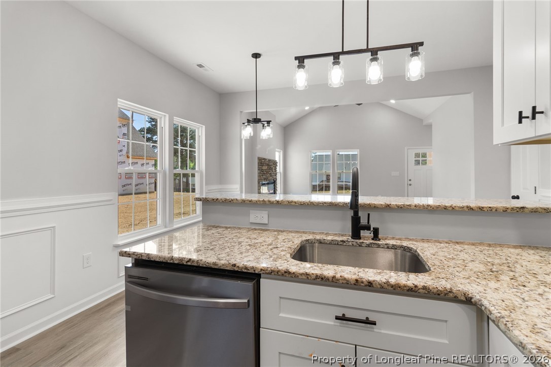 802 Holmes Street Clinton, NC 28328 - Photo 11 of 31 a kitchen with granite countertop a sink a counter top space and cabinets
