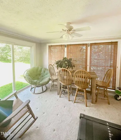 a view of a dining room with furniture window and outside view