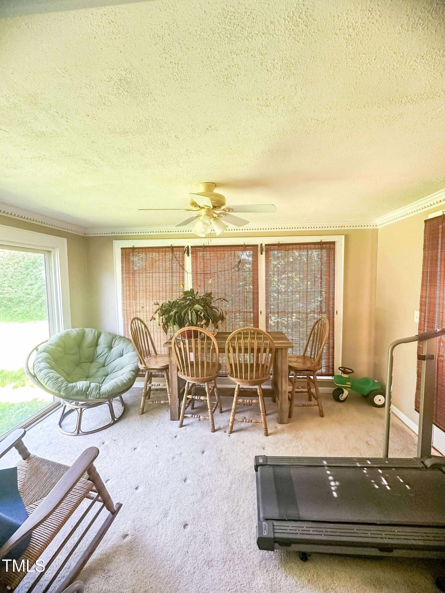 8683 Highway 15 Bullock, NC 27507 - Photo 21 of 36 a dining room with furniture and a large window