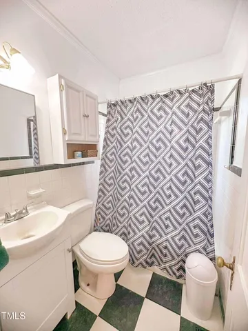 a white toilet sitting next to a bathroom sink