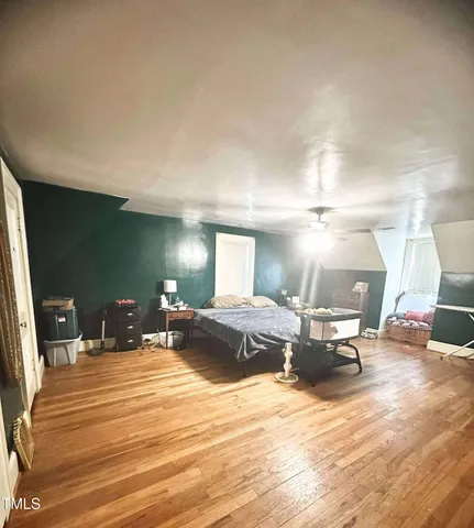 a bedroom with a bed window and lamp