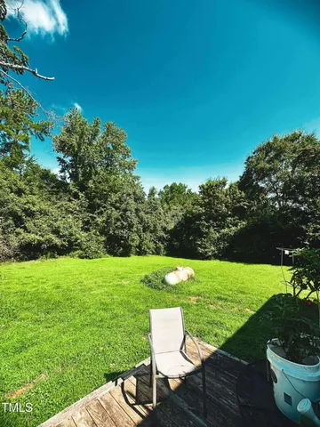 a view of a garden with lawn chairs