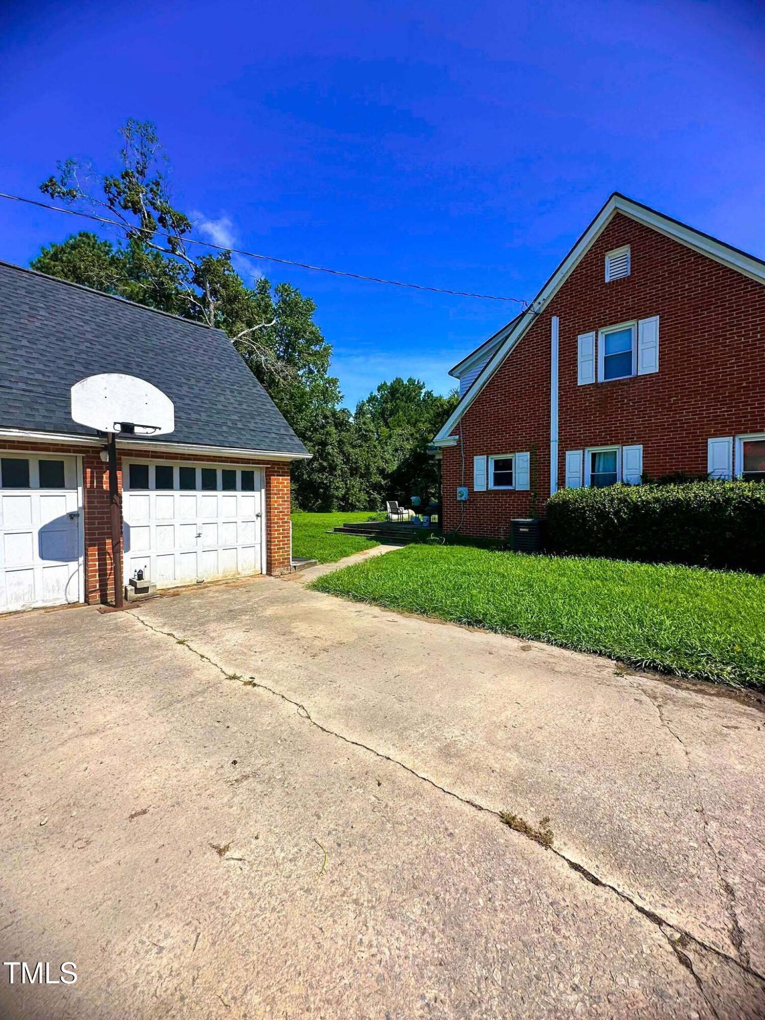 8683 Highway 15 Bullock, NC 27507 - Photo 35 of 36 a front view of a house with a yard and garage