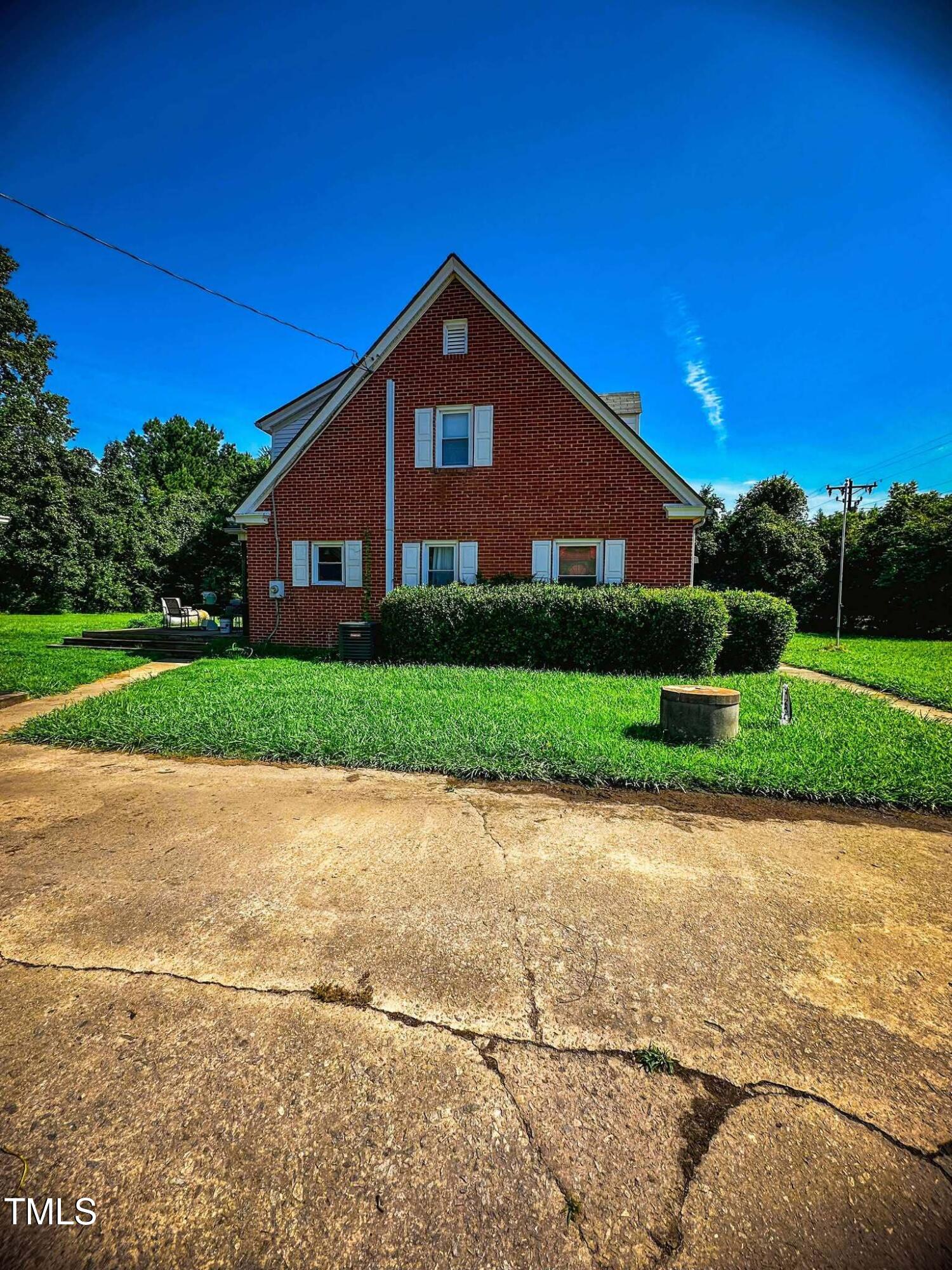 8683 Highway 15 Bullock, NC 27507 - Photo 7 of 36 a front view of a house with a yard