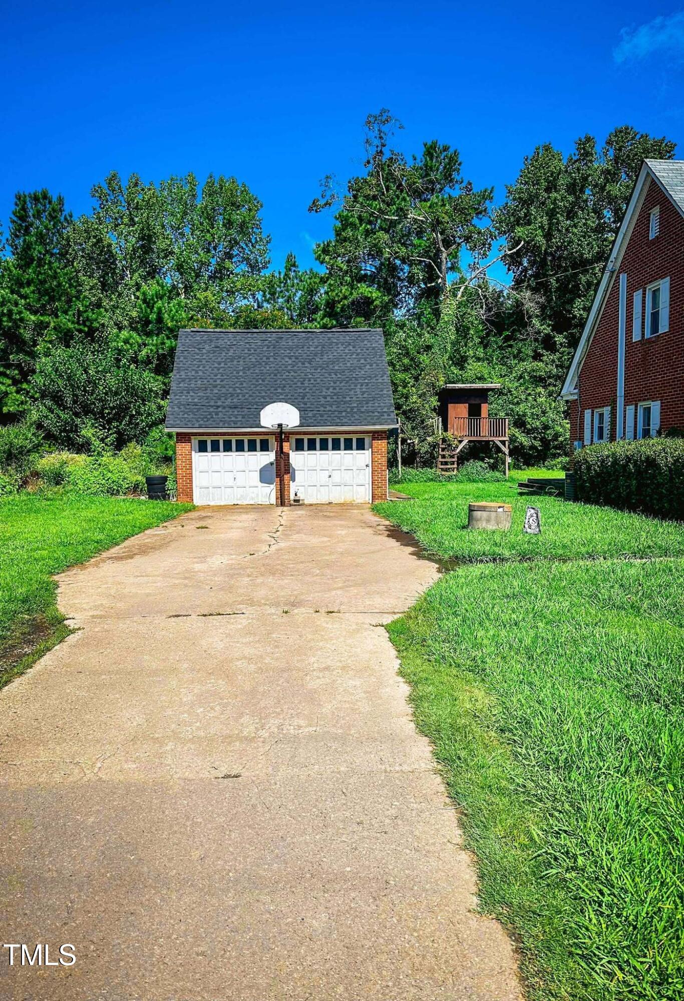 8683 Highway 15 Bullock, NC 27507 - Photo 8 of 36 a house view with a garden space
