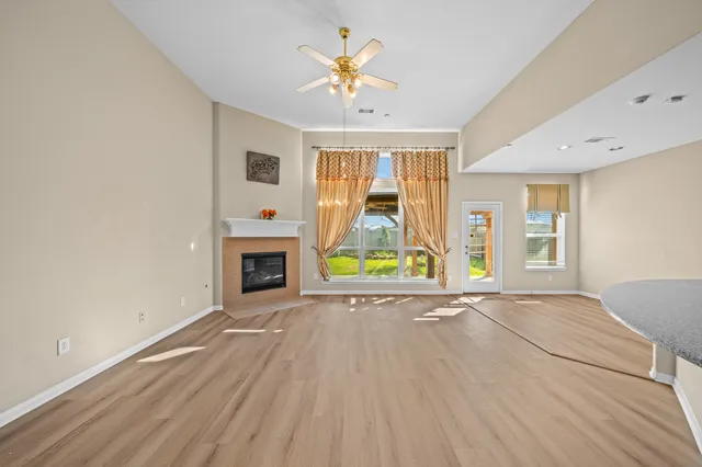 a view of an empty room with a fireplace and a window